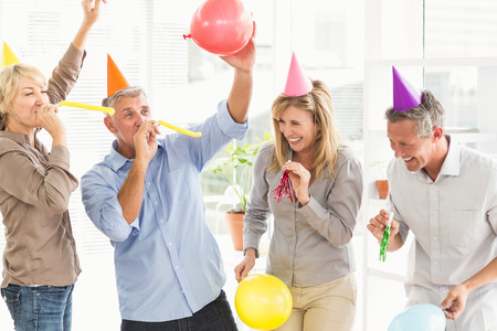 44461073 - laughing casual business people celebrating birthday in the office